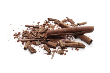 Cinnamon sticks with powder and shavings, macro isolated on white background