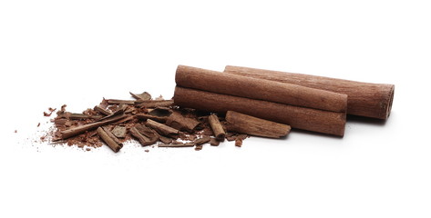 Cinnamon sticks with powder and shavings, macro isolated on white background