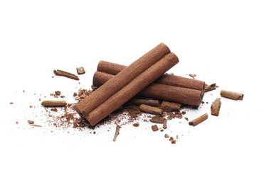 Cinnamon sticks with powder and shavings, macro isolated on white background