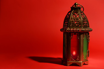 Muslim lamp as Ramadan symbol on color background