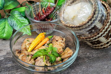 Spicy Minced Pork Salad and Thai sticky rice in a bamboo wooden old style box.Thai food style.