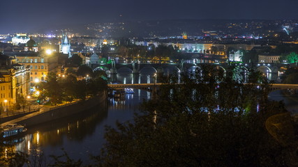 Fototapeta na wymiar Aerial night view of the Vltava River and illuminated bridges timelapse, Prague