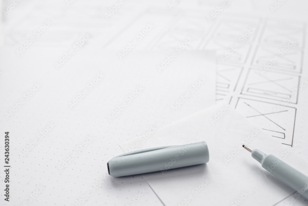 Wall mural ux website designer drawing wireframe sketch of prototype, framework, layout future project. creativ