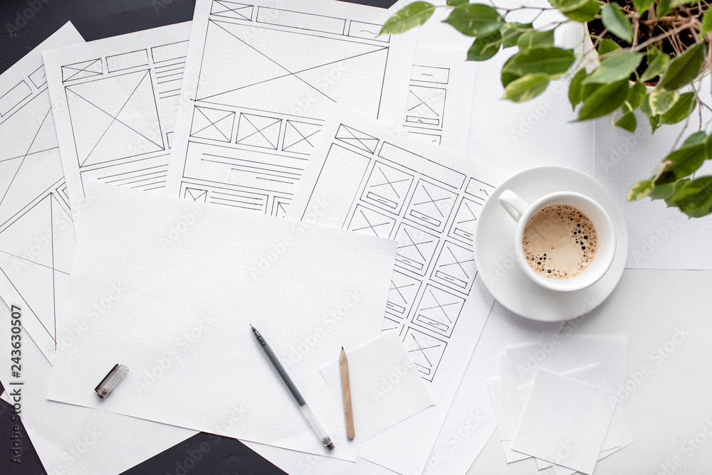 Wall mural ux website designer drawing wireframe sketch of prototype, framework, layout future project. creativ