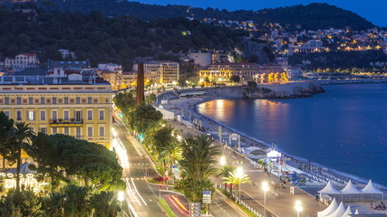 Obraz premium Evening aerial panorama of Nice day to night timelapse, France. Lighted Old Town little streets and waterfront after sunset