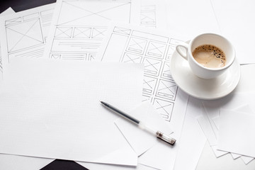 UX website designer drawing wireframe sketch of prototype, framework, layout future project. Creative user experience concept website template. Designer workspace