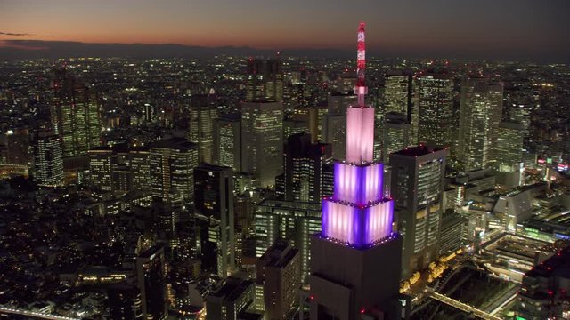 Tokyo, Japan circa-2018.  Aerial view of Docomo Tower and Tokyo skyscrapers at night. Shot from helicopter with RED camera.