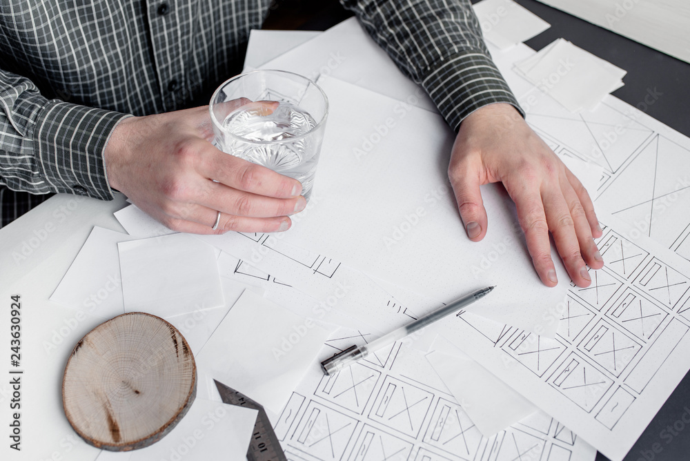 Wall mural ux website designer drawing wireframe sketch of prototype, framework, layout future project. creativ