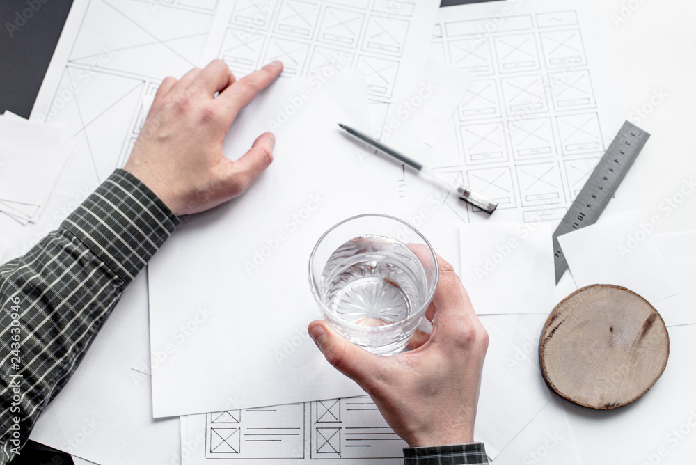 Wall mural ux website designer drawing wireframe sketch of prototype, framework, layout future project. creativ