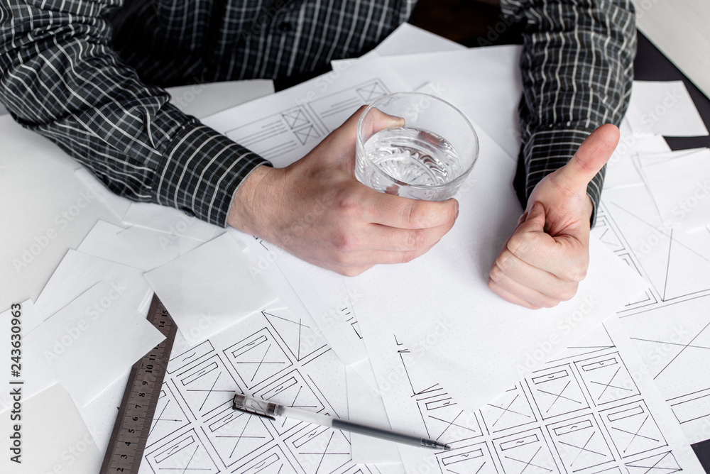 Wall mural ux website designer drawing wireframe sketch of prototype, framework, layout future project. creativ