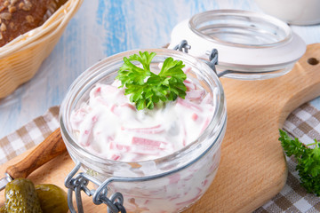 Obraz na płótnie Canvas delicious homemade meat salad with mayonnaise and cucumber