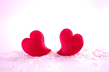 Two red hearts on white and pink glitter on white background, Valentine ' s day concept