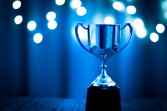 Silver Trophy competition in the dark on the abstract blurred light background with copy space, Blue Tone