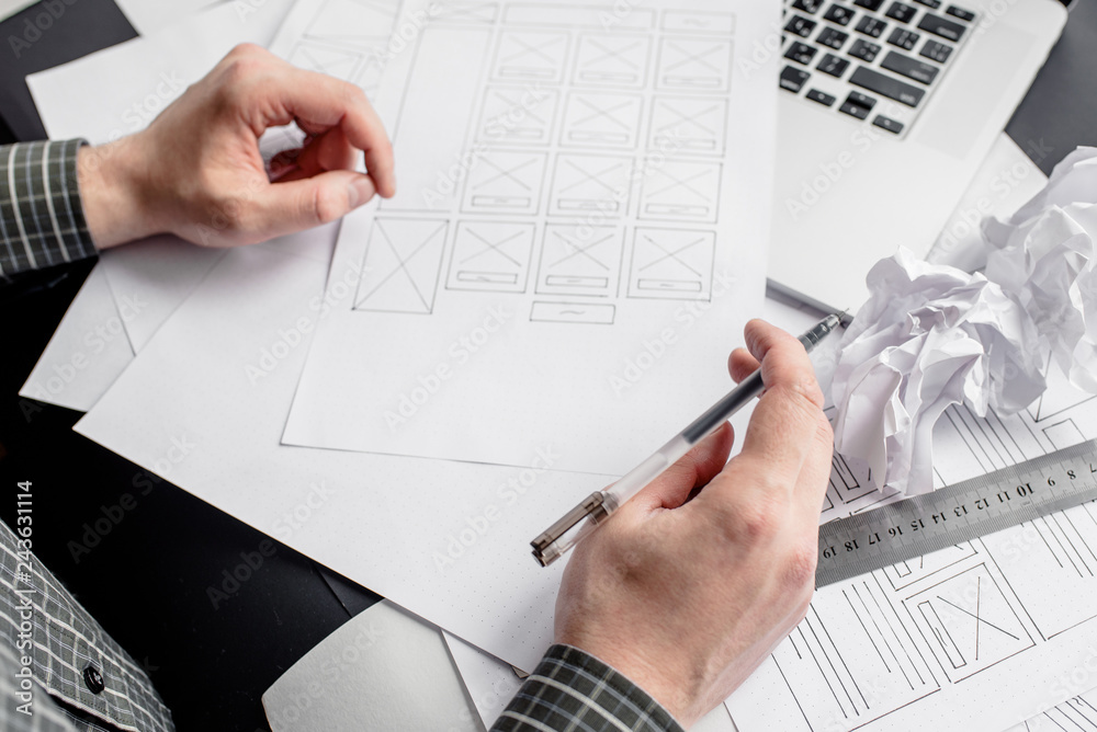 Wall mural ux website designer drawing wireframe sketch of prototype, framework, layout future project. creativ