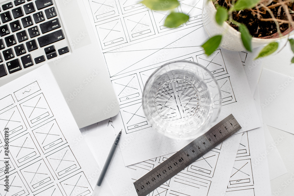 Wall mural ux website designer drawing wireframe sketch of prototype, framework, layout future project. creativ