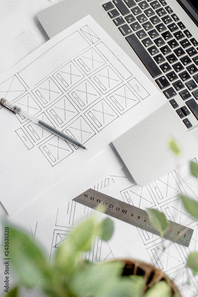 Wall mural ux website designer drawing wireframe sketch of prototype, framework, layout future project. creativ