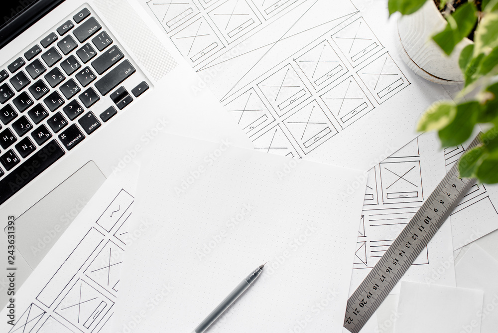 Wall mural ux website designer drawing wireframe sketch of prototype, framework, layout future project. creativ