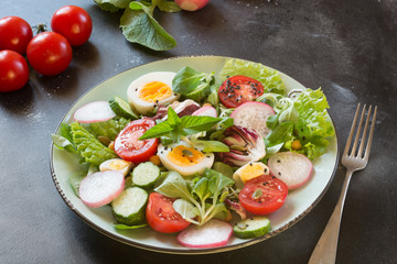 Clean eating. Healthy salad with vegetables and eggs on black. Balanced diet for weight loss.
