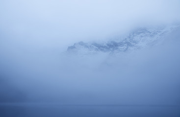 Mountain peaking through fog