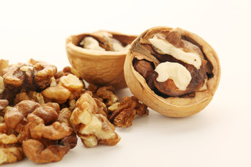 A pile of peeled walnuts at white background	