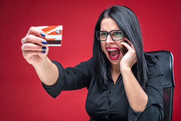 Business woman shocked by her credit card balance, bank fraud concept