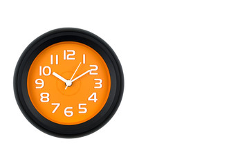 Close-up of the black and orange clock face with three-dimensional numbers. Isolated