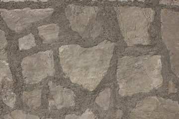 The texture of the walls made of stones bonded with cement
