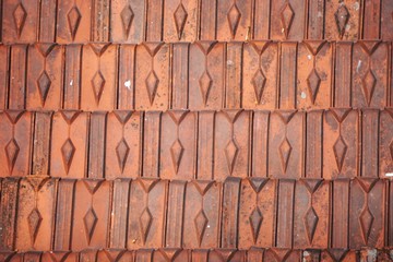 Closeup detail of fired clay roof tiles in Vietnam abstract horizontal background texture