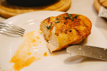 Grilled chicken breast olive oil cherry tomatoes pepper and rosemary herbs.