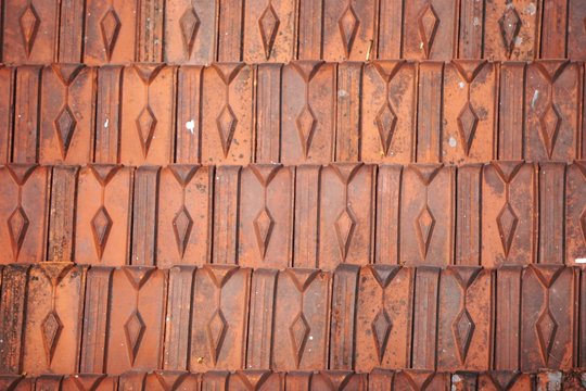 Closeup detail of fired clay roof tiles in Vietnam abstract horizontal background texture