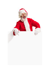 Happy surprised Santa Claus pointing on blank advertisement banner background with copy space. Smiling senior man showing at white blank of empty poster