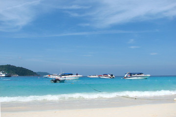 Princess Bay in the Similan Islands, view from the shore. Tourist boats on the blue clear waters of a bay.