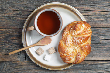 Tea and sweet bun in plate