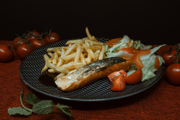 Grilled Salmon with fresh lettuce and Golden French fries