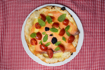 tasty salmon pizza on a the table