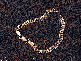 background of black tea leaves. precious ring. decorations.