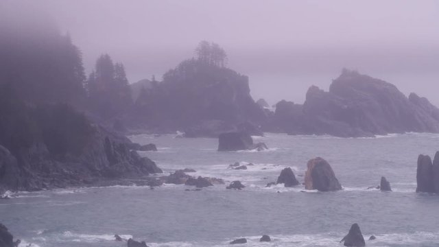 Aerial view of rocky coastline in fog and rain near Juneau