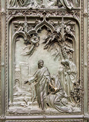 Detail bronze bas-reliefs of the Pieta scene in bas relief at Milan's Cathedral doors