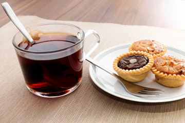 Tea time with hot tea and dessert tarts