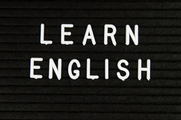 Learn English language, modern looking sign on black background