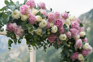 Beautiful wooden wedding arch decorated with flowers outdoors