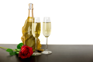 Champagne bottle two glasses and red rose flowers Isolated on white background.