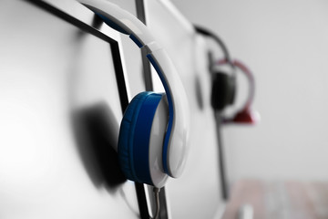 Obraz na płótnie Canvas Headphones on PC monitor in computer club, closeup