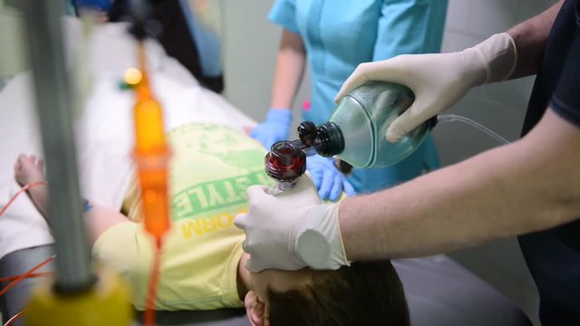 Emergency Department: Doctors, Nurses and Surgeons Move Seriously Injured Patient.