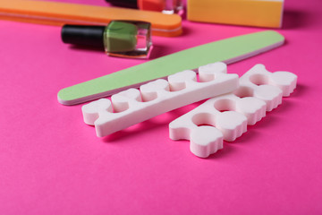 Set of pedicure tools on color background