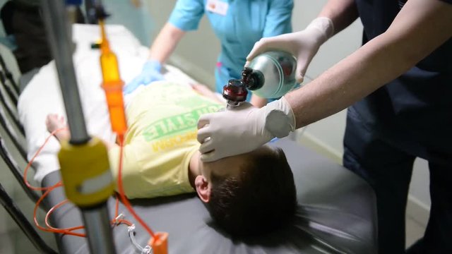 Emergency Department: Doctors, Nurses and Surgeons Move Seriously Injured Patient.