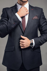 Stylish businessman on grey background