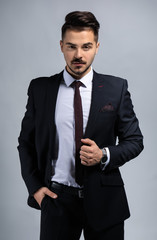 Stylish businessman on grey background