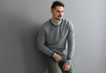 Stylish handsome man on grey background