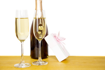 Bottle champagne and two glasses with gift box isolated.